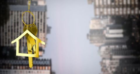 Golden House Key Pendant Against Cityscape Background