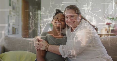 Smiling woman hugging child on sofa with circuit overlay representing family connection
