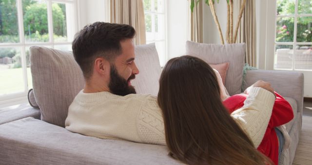 Image of happy caucasian couple resting on sofa. Love, relationship and spending time together concept.