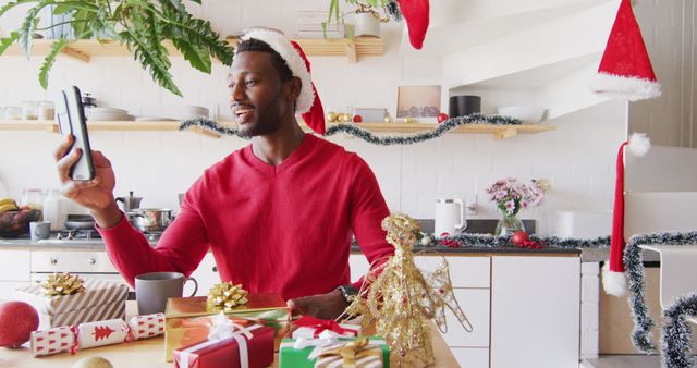 Man in Santa Hat Making Video Call in Festive Kitchen - Download Free Stock Images Pikwizard.com