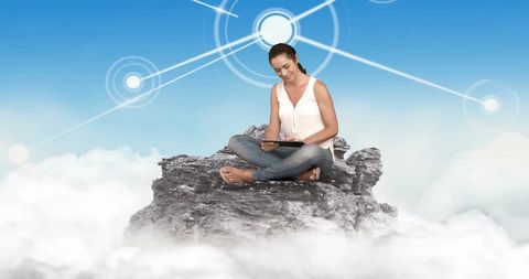 Woman on Rock with Tablet Amidst Digital Network