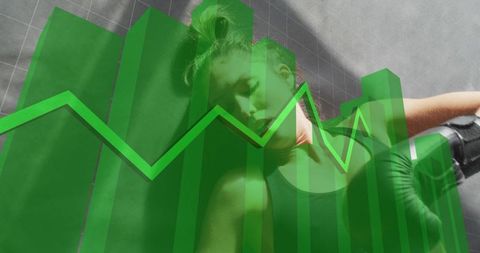 Athlete lying on gym mat holding boxing glove with green financial chart overlay and data bars