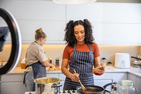 Diverse friends cooking together in shared kitchen experience