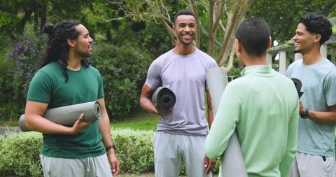 Friends Gathering Outdoors with Exercise Mats for Yoga Session
