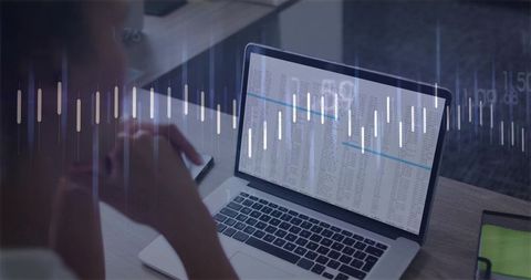 Analyzing financial data on laptop with waveform overlay in modern workspace