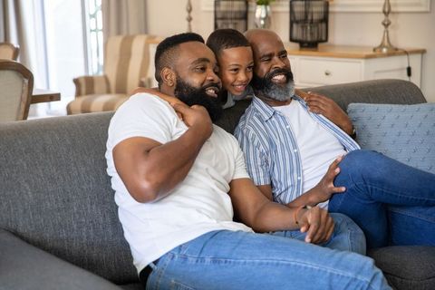 Happy Family Relaxing at Home on Comfortable Sofa