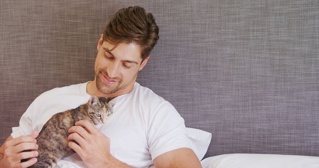 Man Relaxing on Bed with Cozy Kitten at Home - Download Free Stock Images Pikwizard.com