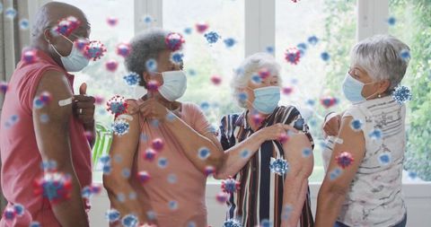 Seniors displaying vaccination bandages wearing masks, mixed-ethnicity community health