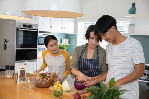 Family Bonding in Modern Kitchen Cooking Fresh Meal Together