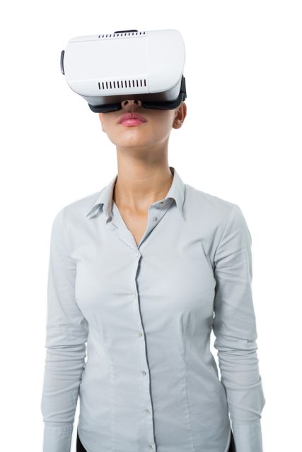 Female executive using virtual reality headset against white background