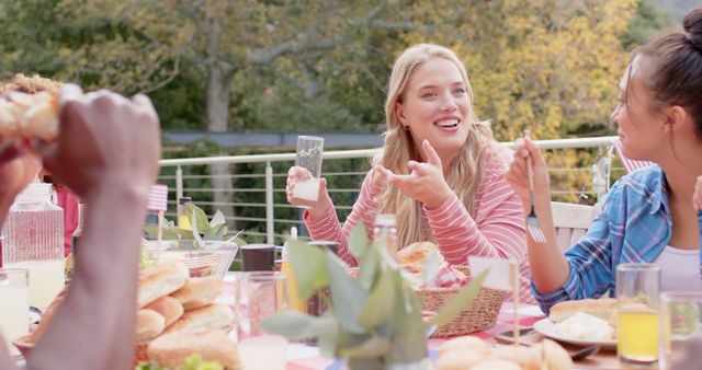 Friends Enjoying Outdoor Meal with Laughter and Conversation - Download Free Stock Images Pikwizard.com