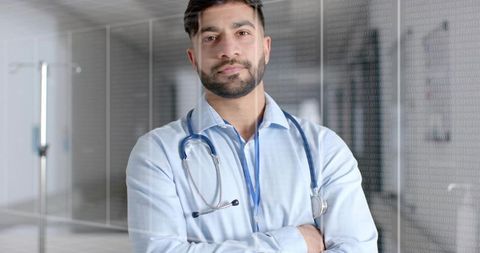 Confident Doctor Standing in Hospital Hallway with Stethoscope