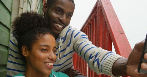 Joyful Couple Taking Selfie on Urban Balcony - Download Free Stock Images Pikwizard.com