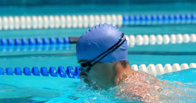 Competitive Swimmer Training in Pool with Blue Swim Cap - Download Free Stock Photos Pikwizard.com