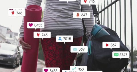 Activewoman Engaged with Social Media While Headed to Urban Workout