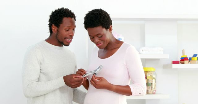 Expectant Parents Looking at Ultrasound Photo Together - Download Free Stock Images Pikwizard.com