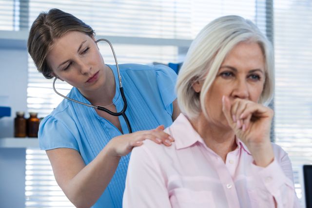Doctor Examining Coughing Patient in Clinic - Download Free Stock Photos Pikwizard.com