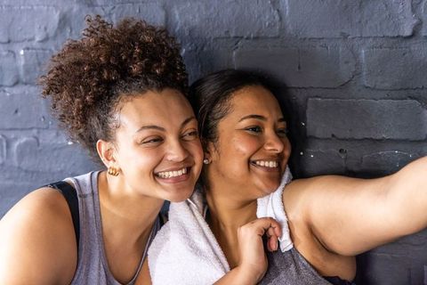African american friends taking gym selfie after workout smiling and laughing together