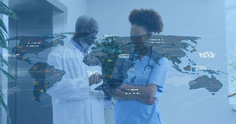 African American doctor and nurse collaborating with tablet showing global health data