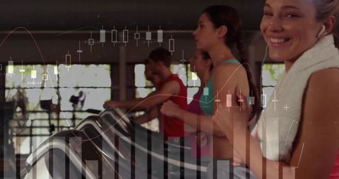 Energetic woman running on treadmill with towel and earphones in gym