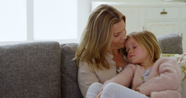 Loving Mother Comforting Her Sleeping Daughter on Couch - Download Free Stock Images Pikwizard.com