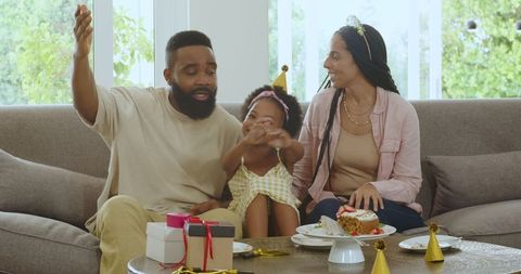 Family Celebrating Birthday Together at Home with Gifts and Cake