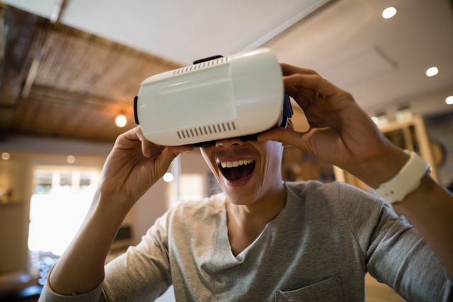 Man enjoying virtual reality experience in a restaurant. Perfect for illustrating modern technology use in everyday life, VR entertainment, and innovative dining experiences.