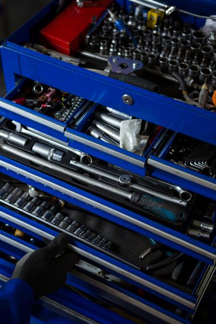 Mechanic's toolbox filled with various tools including sockets, wrenches, and other hand tools, ideal for automotive repair and maintenance. Useful for illustrating professional repair services, mechanical work, and organized tool storage in a workshop or garage setting.