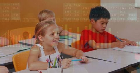 Smiling elementary girl writing worksheet with data charts overlay for digital learning