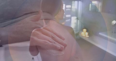 Therapist Massaging Client's Shoulder in Relaxing Spa Atmosphere