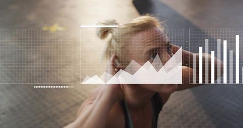 Mid-adult woman performing crunches with fitness data overlay for workout tracking