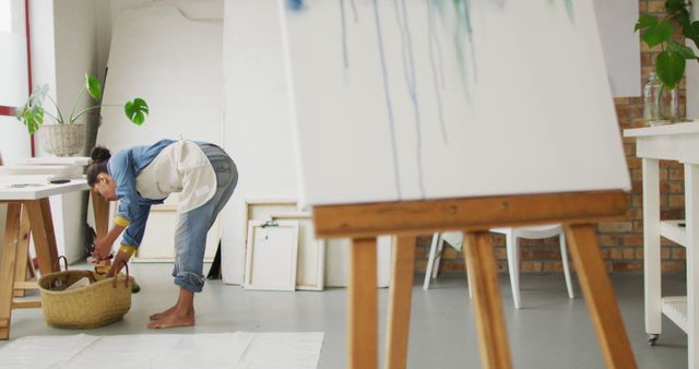 Artist Preparing Supplies in Studio with Canvas and Easel - Download Free Stock Images Pikwizard.com