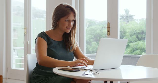 Young Professional Woman Working at Laptop in Modern Office - Download Free Stock Images Pikwizard.com