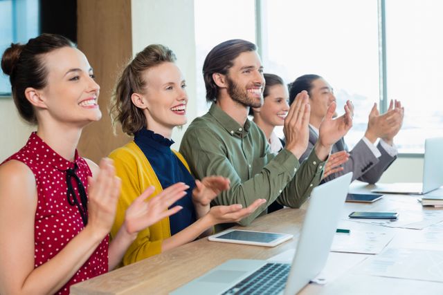 Business team applauding during meeting in conference room at office