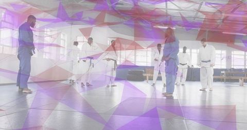 Instructor leading mixed-level judo and Brazilian jiu-jitsu class with students practicing on mats