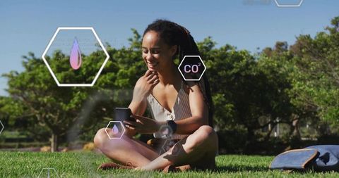 Woman Using Smartphone and Smartwatch for Technology and Relaxation Outdoors