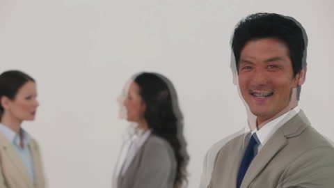 Businessman Laughing Confidently with Colleagues