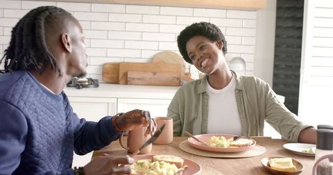African American Couple Enjoying Breakfast in Cozy Kitchen Interior