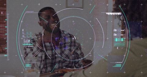 Laughing man enjoying casual meal with futuristic hud overlays and cozy dining atmosphere