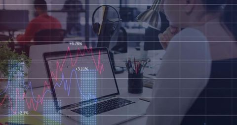 Professional woman analyzing financial data on laptop in open workspace