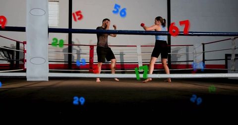 Sparring partners trading punches inside boxing ring with colorful number overlays during training