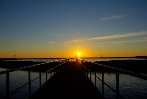 Sunrise Over Calm Pier During Peaceful Morning