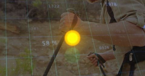 Hiker with trekking poles exploring rocky trail