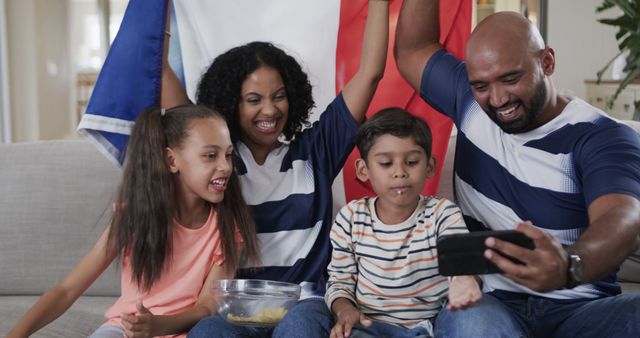 Excited Family Cheering Together While Watching Game on Mobile Phone - Download Free Stock Images Pikwizard.com