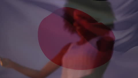 Japanese Flag Overlay on Celebrating Woman with Sparklers