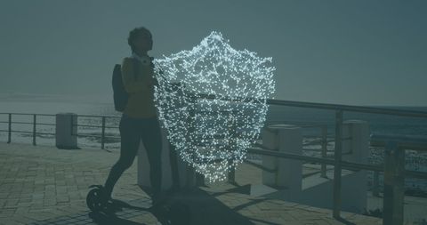 Digital Shield Overlay Woman Riding Scooter by Ocean