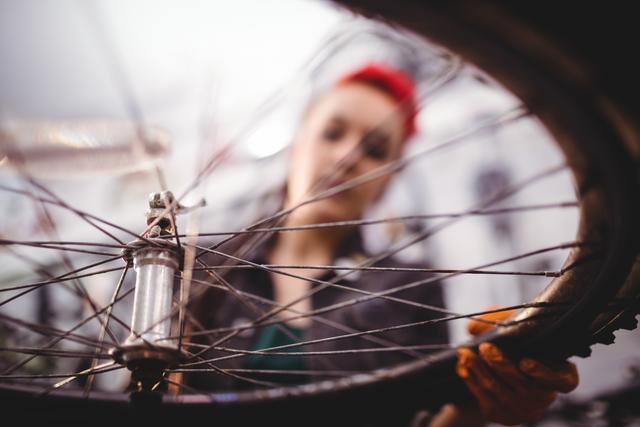 Mechanic Holding Bicycle Wheel in Workshop - Download Free Stock Images Pikwizard.com