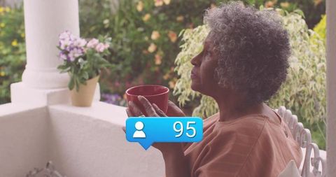 Senior Woman Relaxing with Coffee Appreciating Scenic View