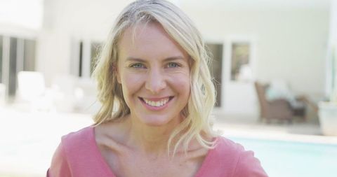 Joyful Woman Smiling by poolside on Sunny Day
