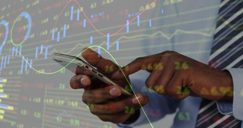 Businessman tapping smartphone while analyzing stock market charts and candlesticks overlay